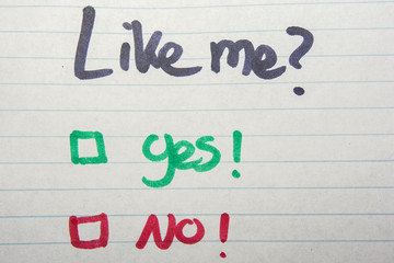 Like me, yes or no written on piece of paper