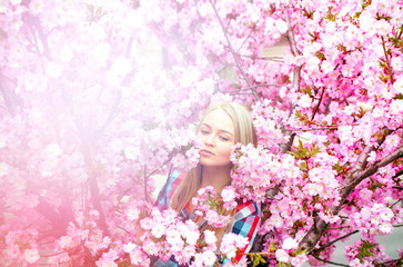 Obraz na płótnie Canvas relaxed girl enjoying blooming flowers