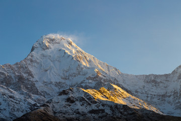 Sunrise rays on the peak of Annapurna South from Tadapani, Nepal