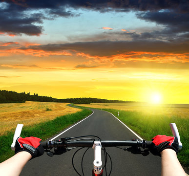 Cyclist riding a bike in the sunset