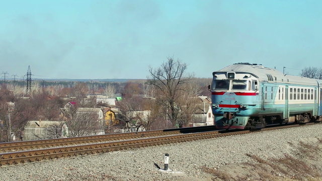 Passenger train with carriages passing by from distancing away