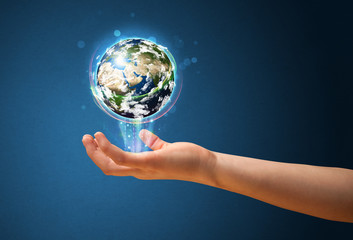 Woman holding a glowing earth globe