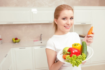 Woman holds plate with vegetables