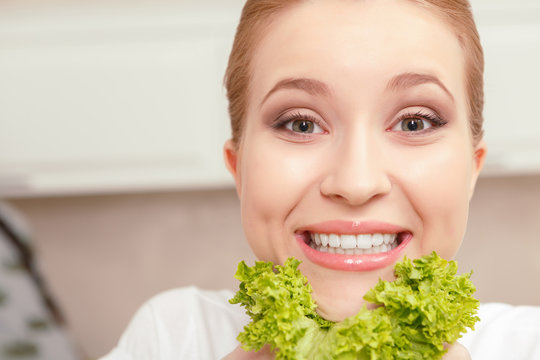 Lady smiles while holding salad