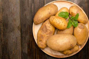 Potatoes on wooden plate