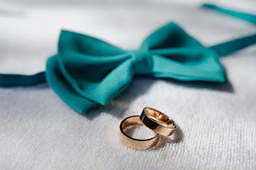wedding rings on a background of blue bow tie