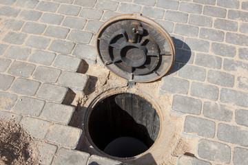 Sewer hole in a brick road