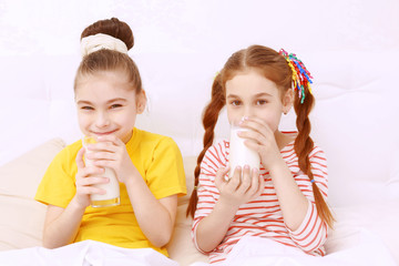 Bright dressed children drinking milk