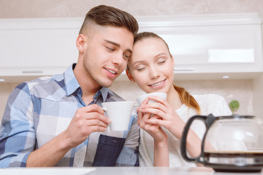 Young couple sitting and drinking coffee