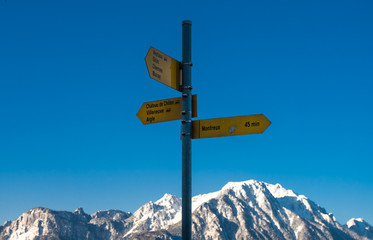 Directions where to go in mountains in front of blue sky, summer