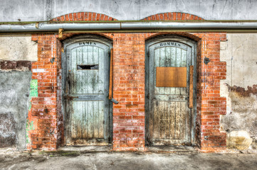 Fototapeta na wymiar Old toilet doors in an abandoned factory