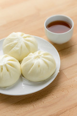 Chinese steamed buns on wood background