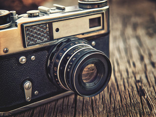 old vintage camera closeup on wooden background