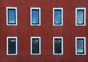Eight Windows on Red Brick Wall