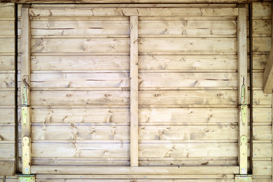 Exterior view of a closed wooden window of a cabin