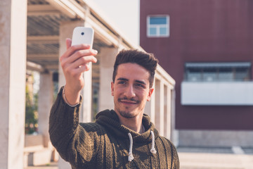 Young handsome man taking a selfie