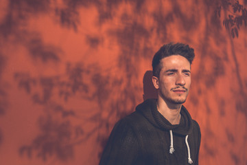 Young  man posing in an urban context