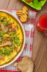 Omelette with smoked meat and mushrooms
