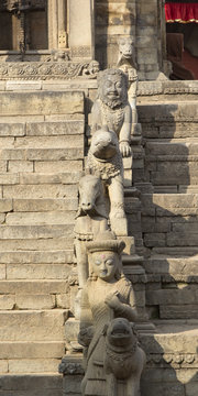 Statues on the steps of an ancient temple in Bhaktapur, Nepal