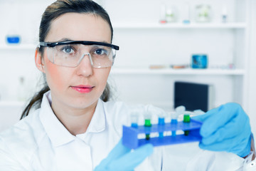 female researcher with glass equipment in the lab.