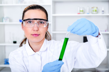 female researcher with glass equipment in the lab.
