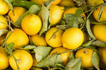 a few lemons in a wooden crate for sale
