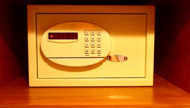 Entering code and removing money from hotel safe 