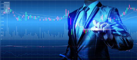 double exposure of businessman with stock market chart