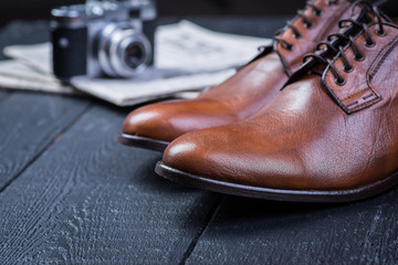 Brown leather shoes on black floor