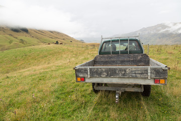 A pickup truck on a farm in the mountains - 82266560