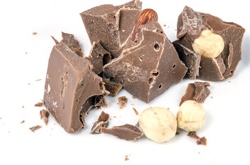 Broken chocolate piece with nuts isolated on white