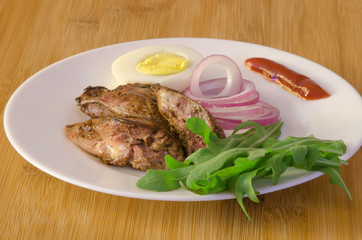 Roasted chicken liver with vegetable on wooden background