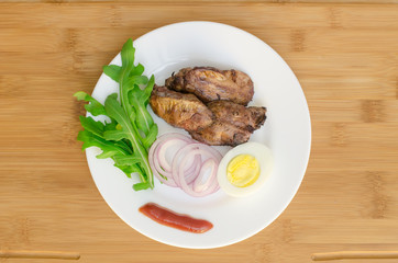 Roasted chicken liver with vegetable on wooden background