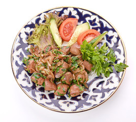 Fried meat with onion in a frying pan