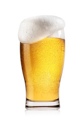 Glass of light beer with white foam