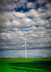 Wind Turbine in the Distance Under Cloudy Sky