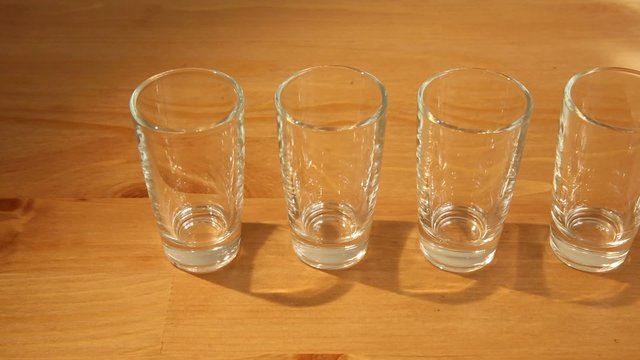 Shot of a row of many small wine glasses