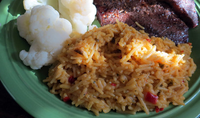 Sunlight from a window falls on a closeup of spicy, Mexican rice