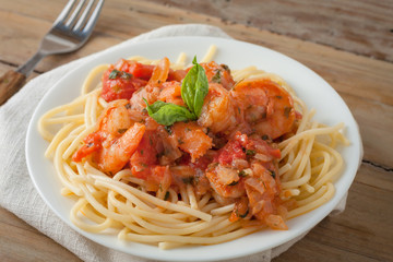 shrimp in wine tomato sauce over spaghetti pasta