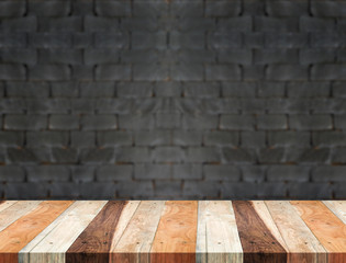 Empty tropical wood table and blurred black brick wall backgroun