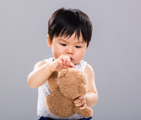 Baby play with the doll bear