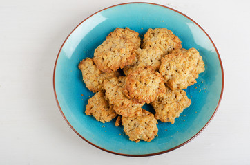 Freshly baked oatmeal cookies in a blue plate.