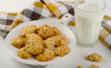 Oatmeal cookies and a glass of milk.