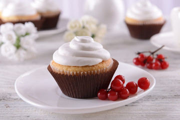 Delicious cupcakes on table on light background