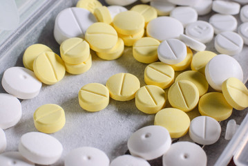 white and yellow  round medicine tablet