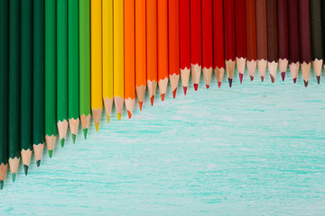 Colorful pencils on wooden table