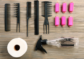 Hairdressing tools on wooden background