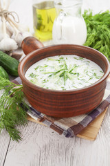 Summer soup with cucumbers, yogurt and fresh herbs