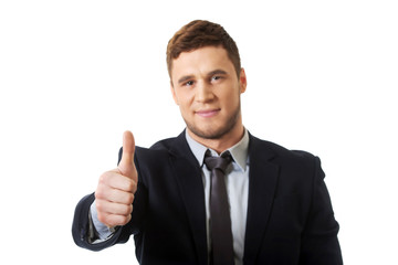 Happy smiling businessman with thumbs up.