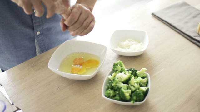 Man Hand Adding Salt To Eggs